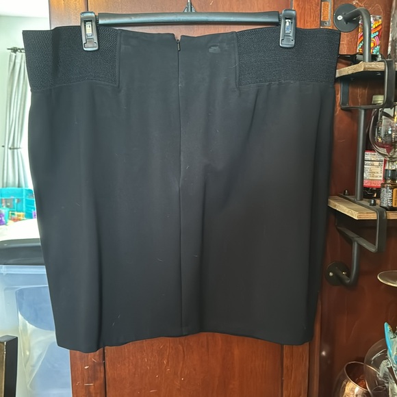 Black fitted skirt. Poly/Nylon/Spandex. Zipper in the back. Elastic waistband. - Picture 3 of 3
